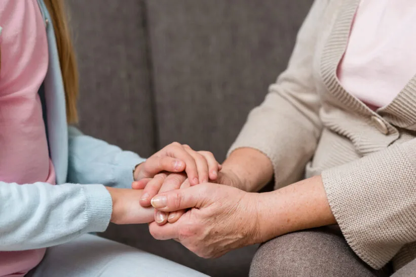 zbliżenie na dłoń seniorki i jej opiekunki